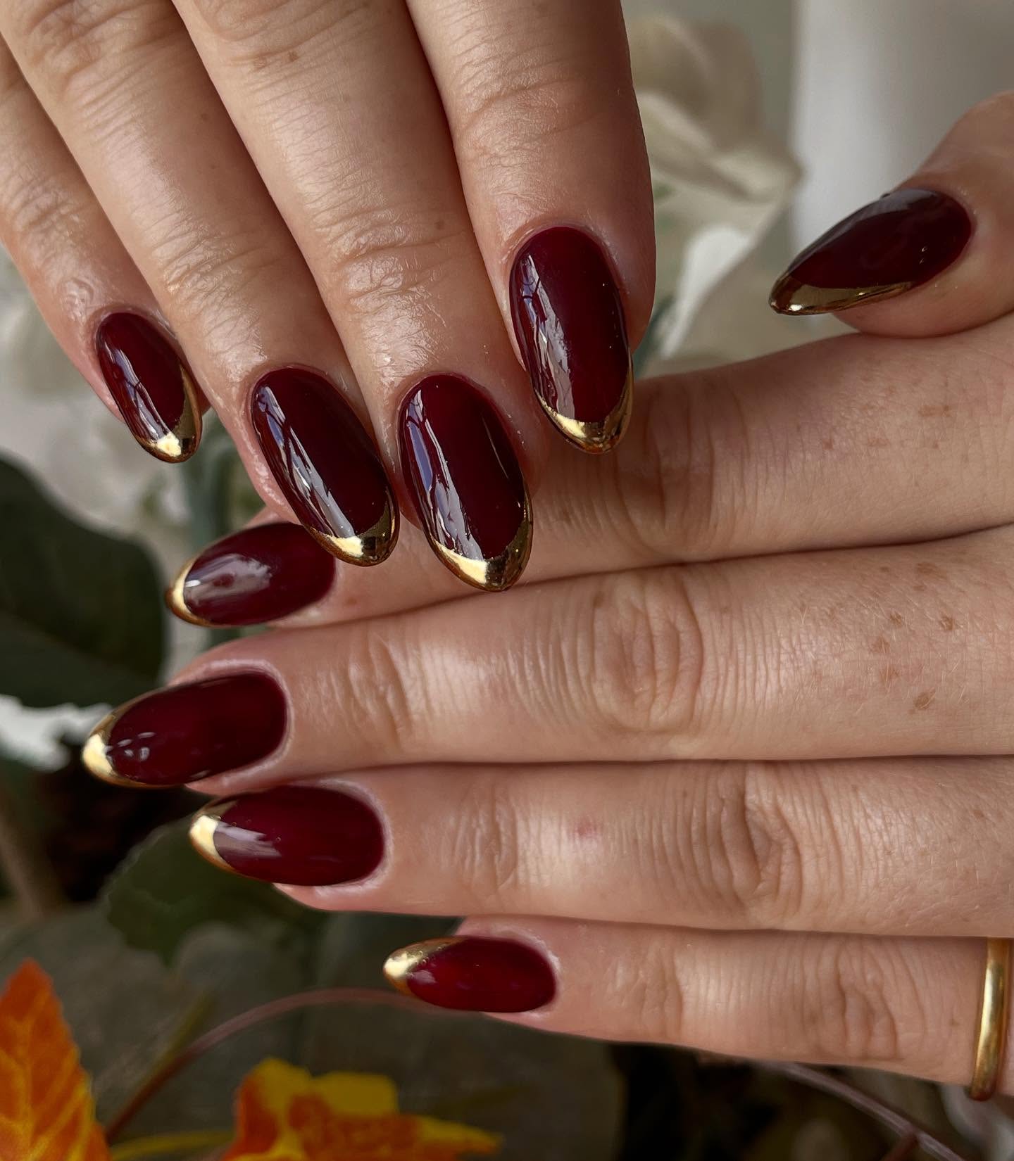 Deep Red Glossy Nails with Gold French Tips