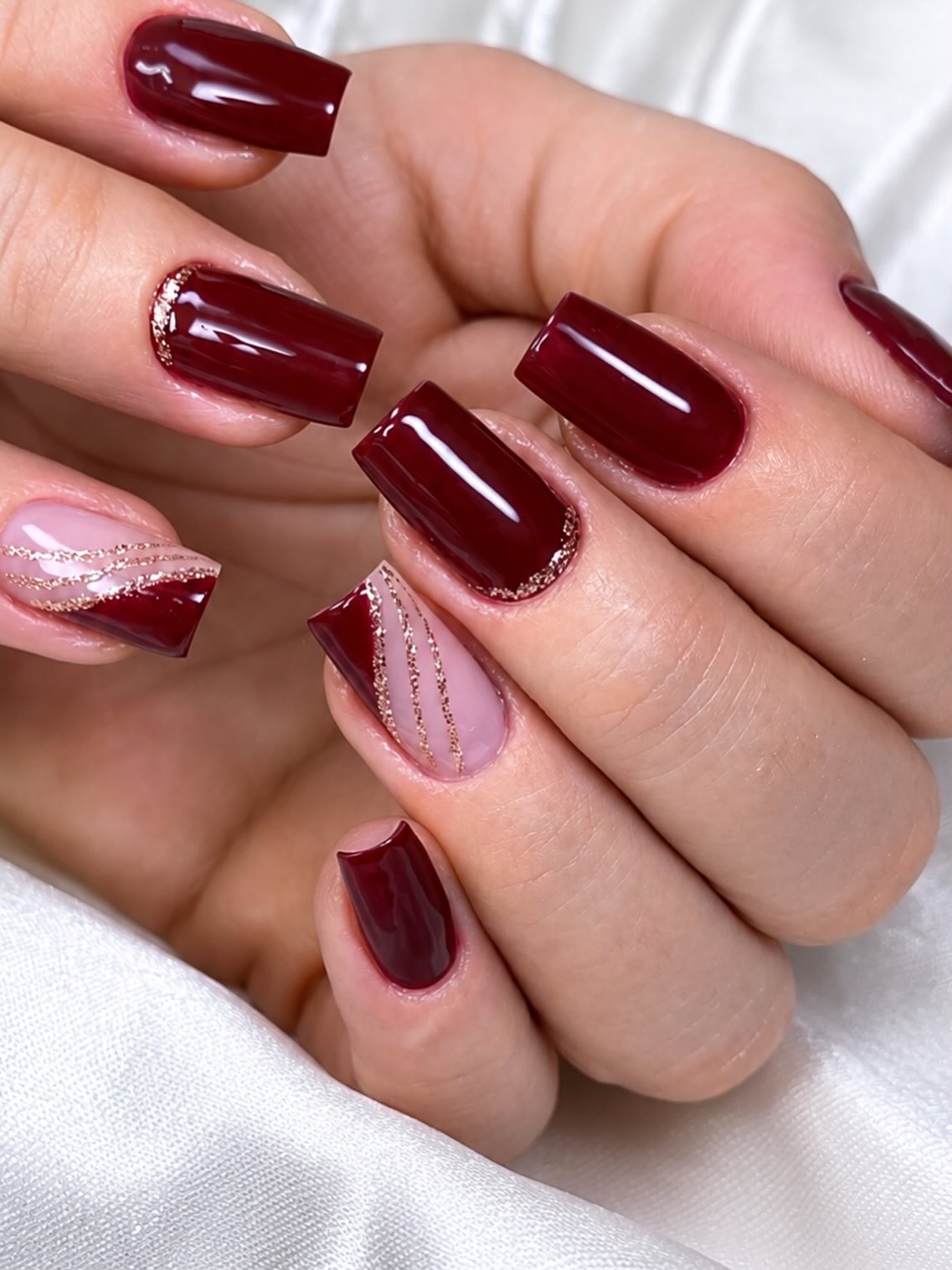 Deep Cherry Red Glossy Nails with Rose Gold Accents