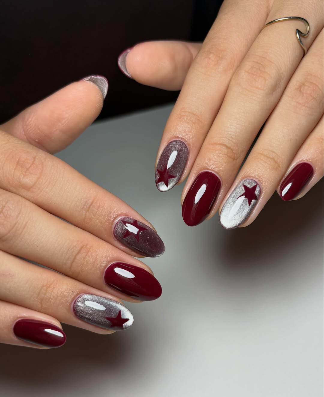 Deep Burgundy Oval Nails with Silver Star Accents