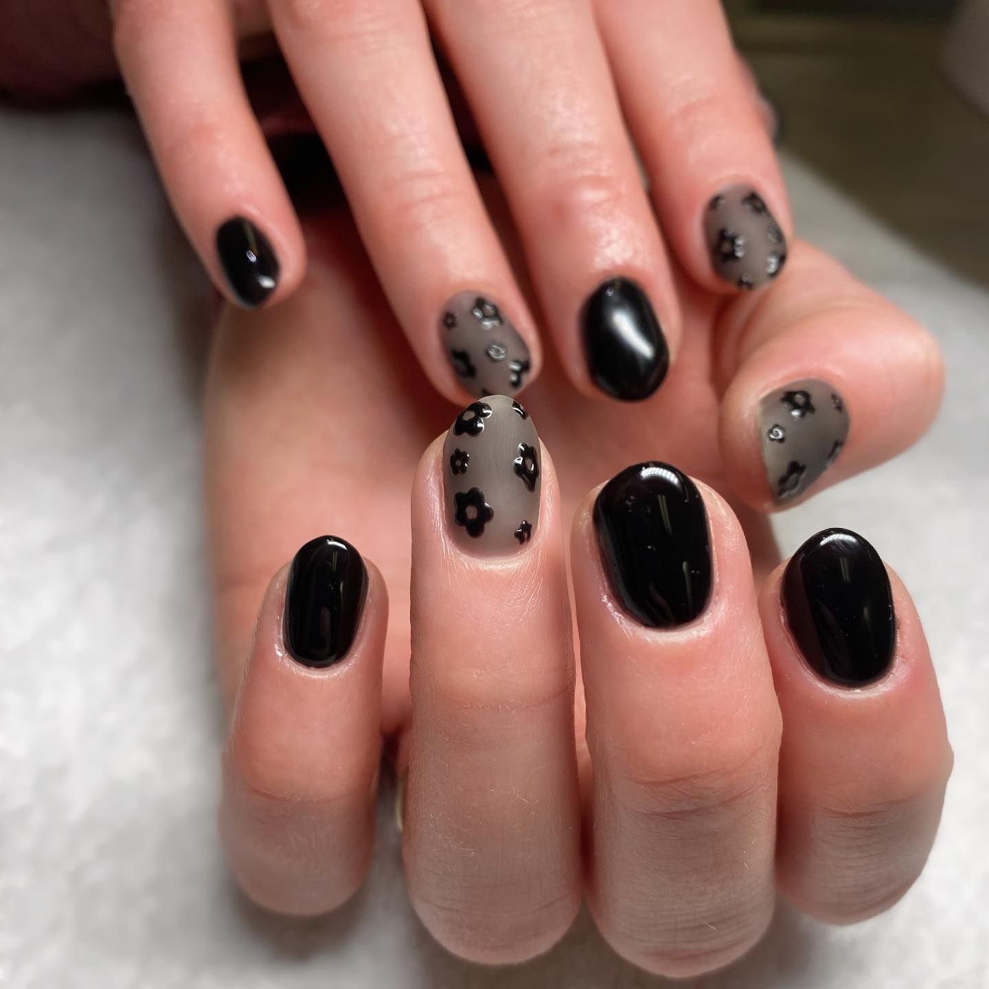 Glossy Black Nails with Matte Flower Accents