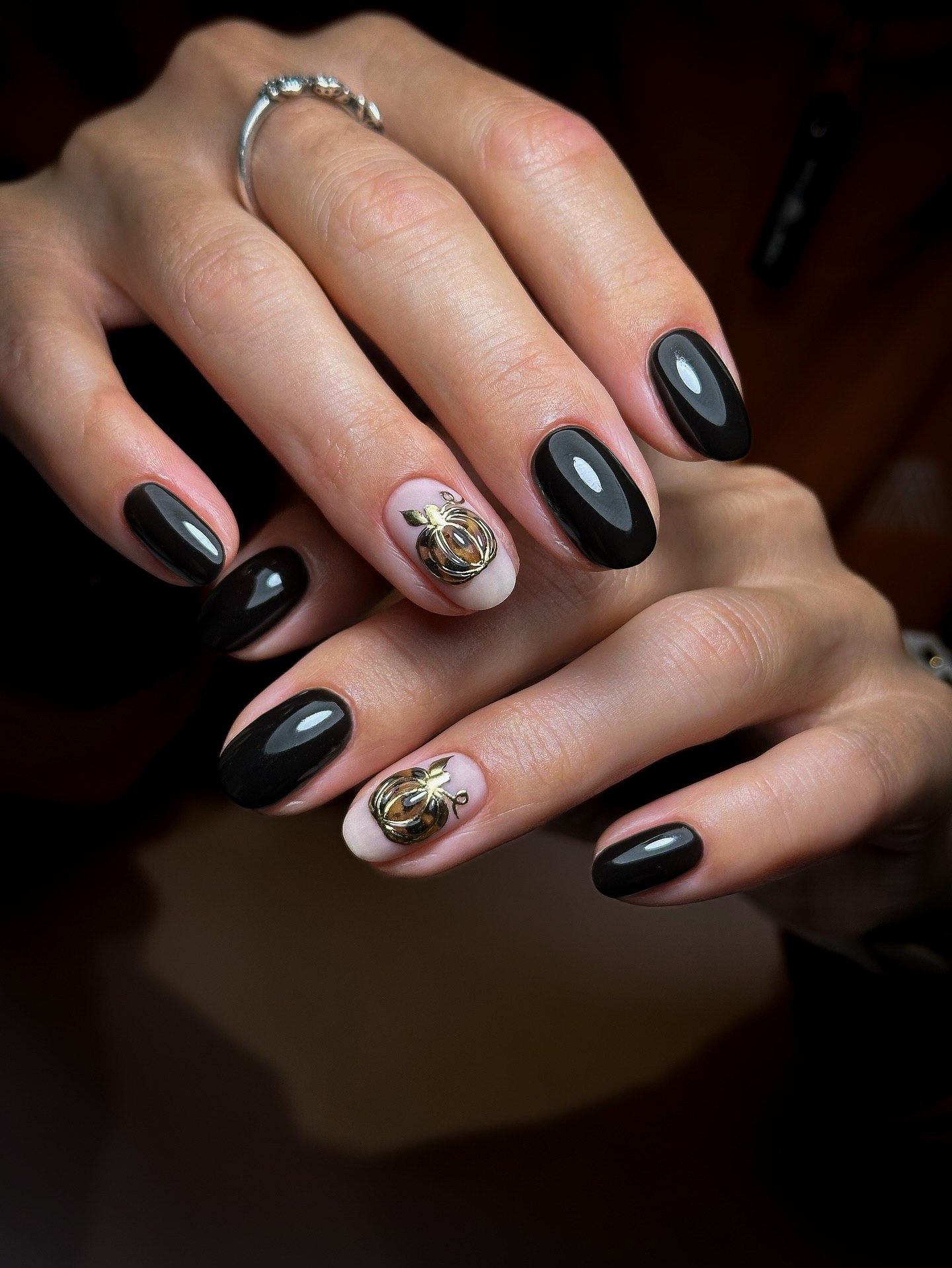 Glossy Black Oval Nails with Gold Pumpkin Charms
