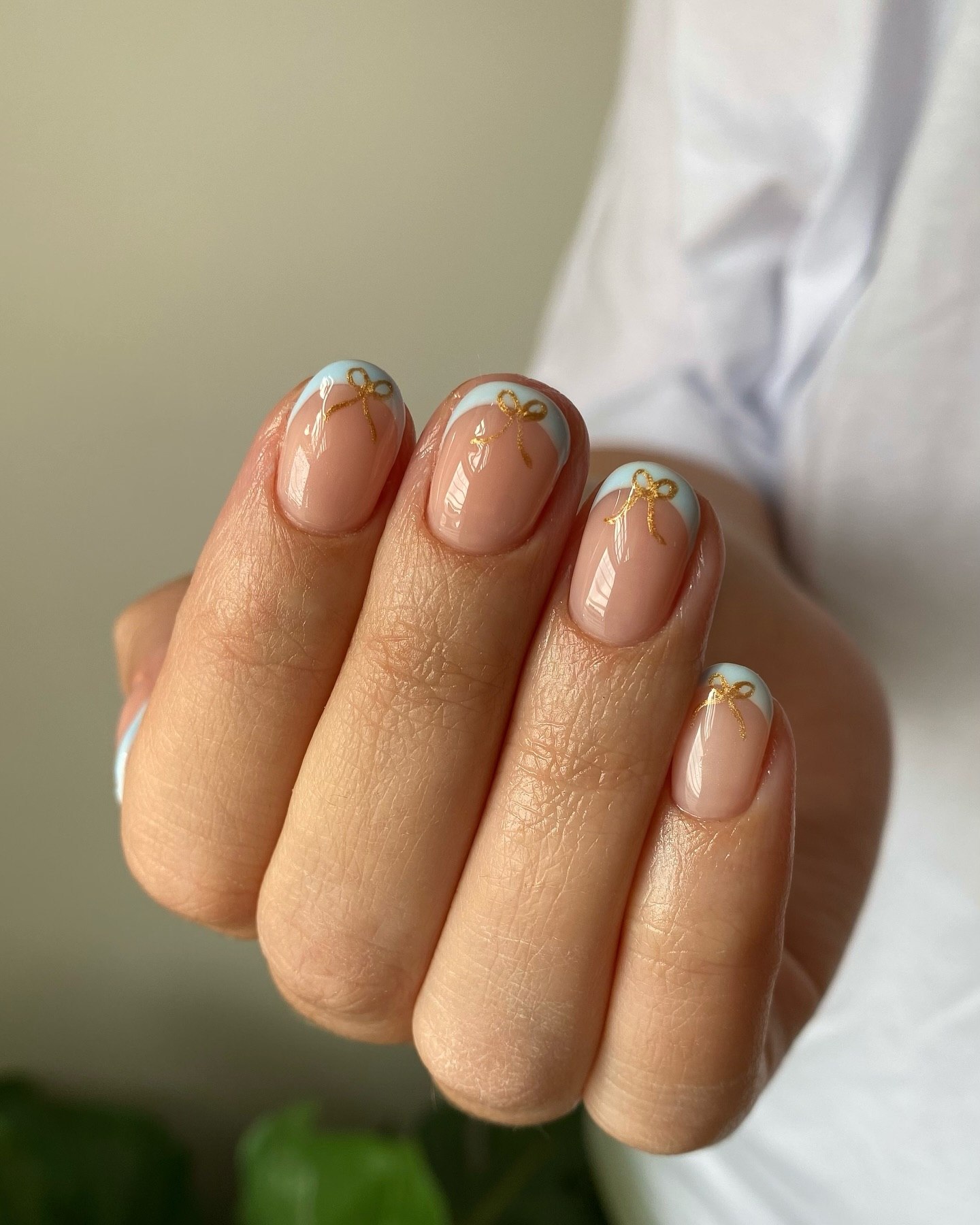 French Tip Nails with Delicate Gold Bow Detail