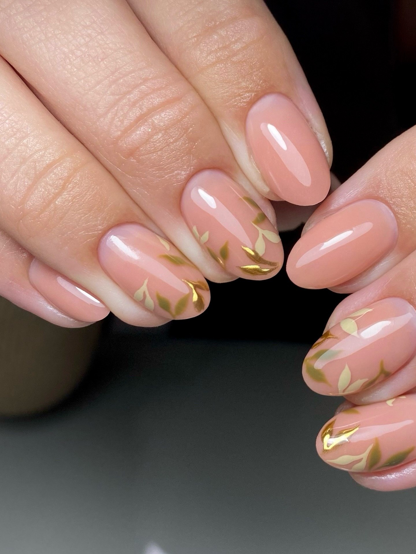 Soft Peach Oval Nails with Gold Leaf Accents