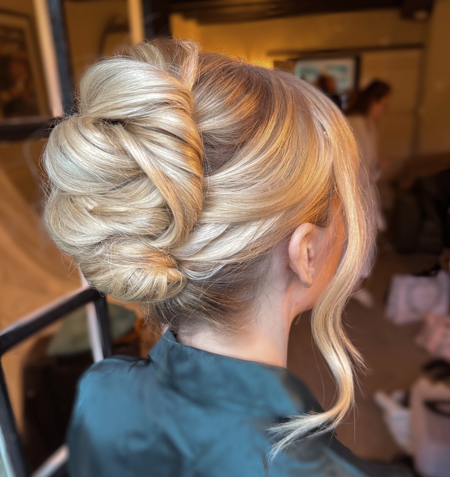Voluminous Textured French Twist With Face Framing Tendrils