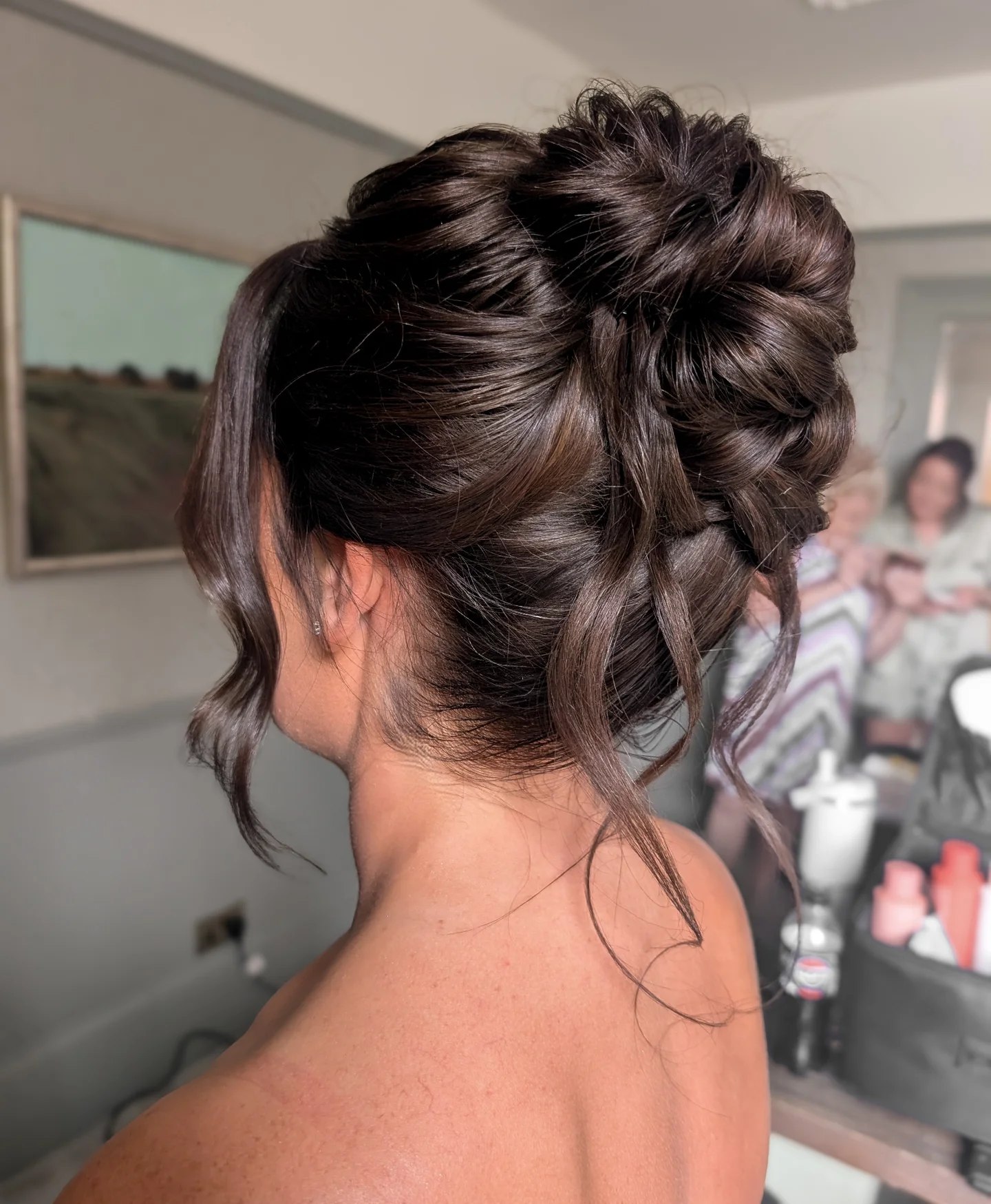 Voluminous Textured Updo With Face Framing Tendrils