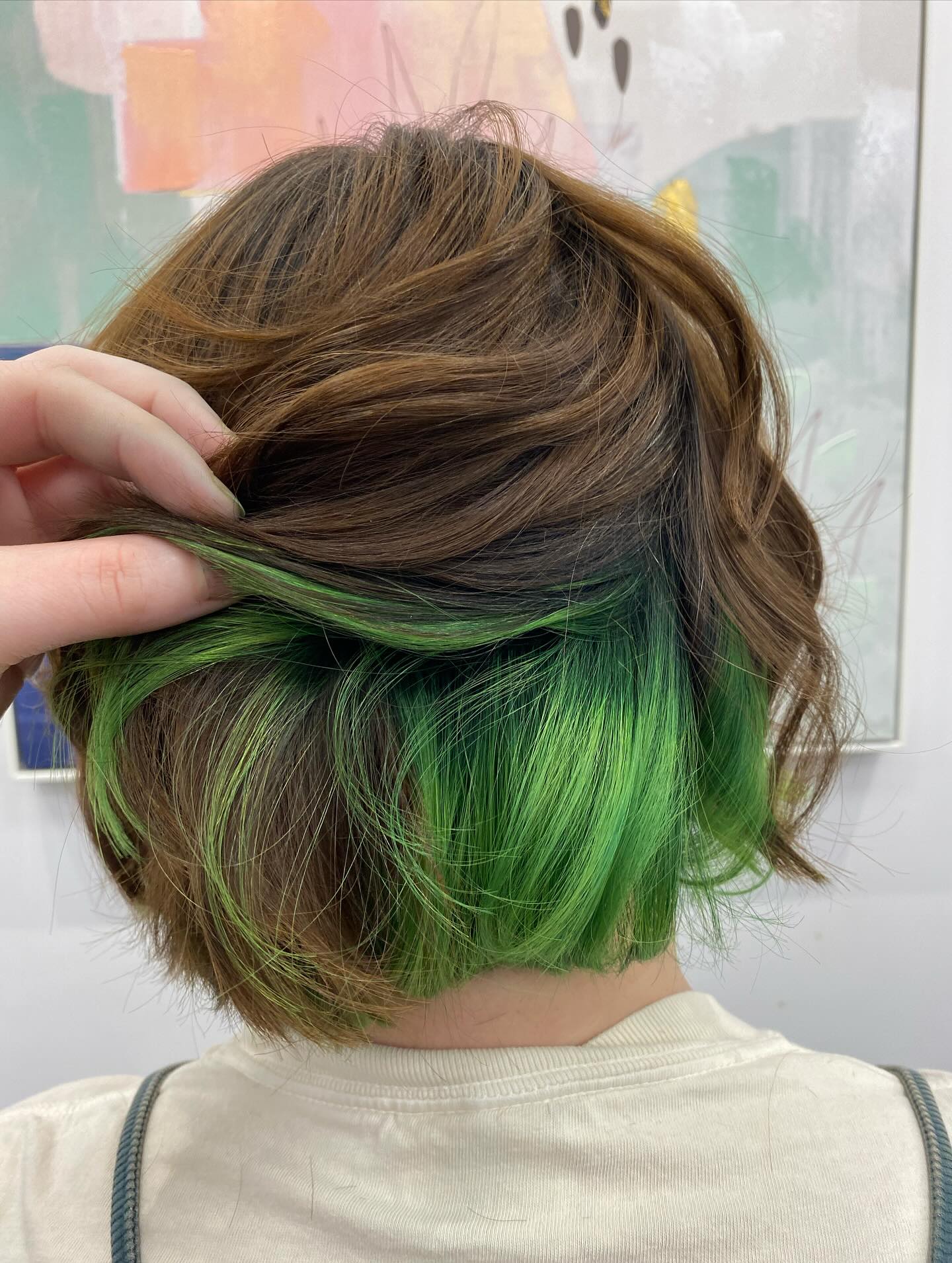 Vibrant Emerald Peekaboo Highlights On Brunette Bob