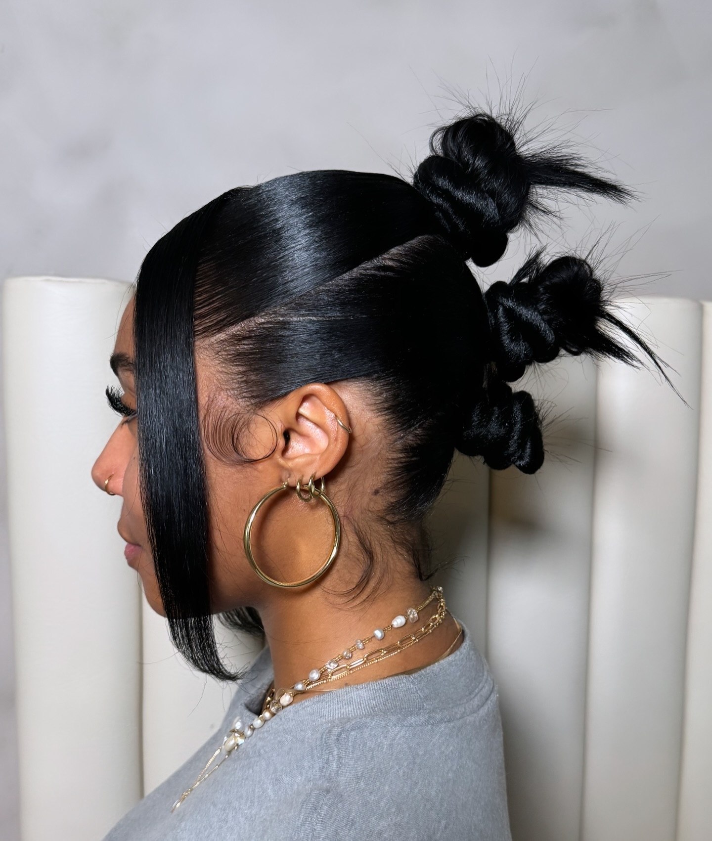 Sleek High Top Knots With Wispy Face Framing