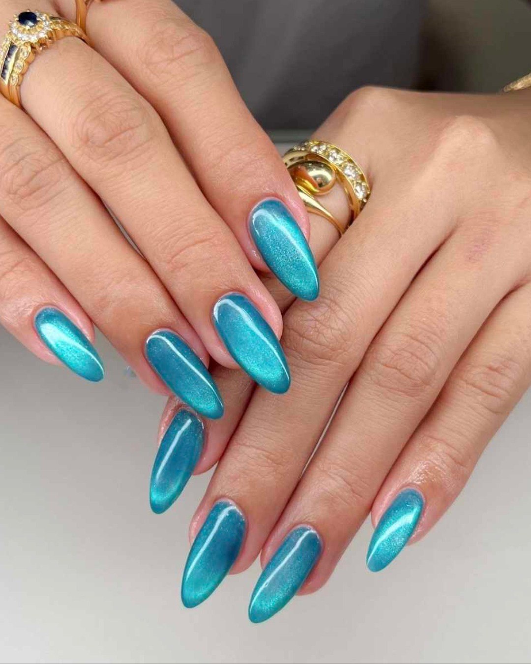 Teal Cat Eye Almond Chrome Nails