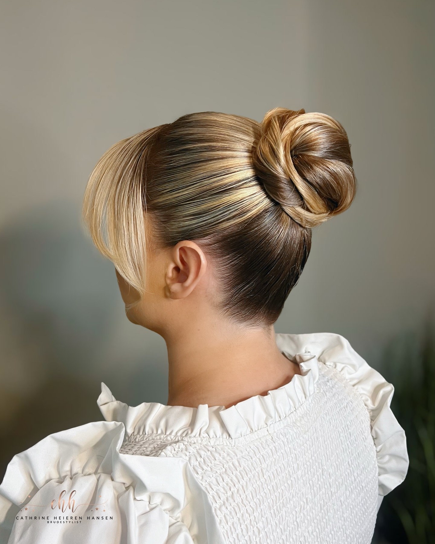 Sleek High Twisted Bun With Face Framing Pieces