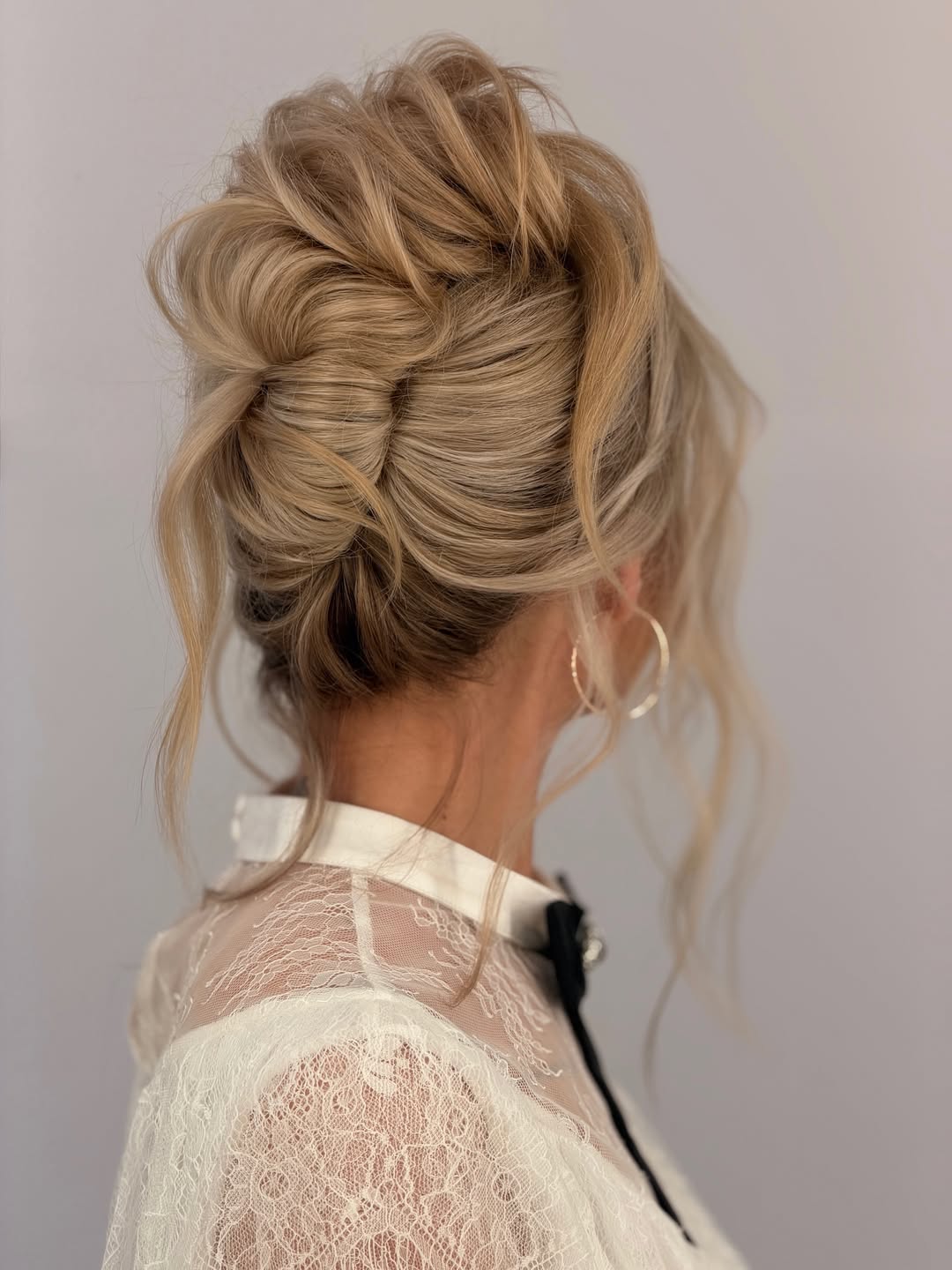 Textured Voluminous Updo With Loose Strands