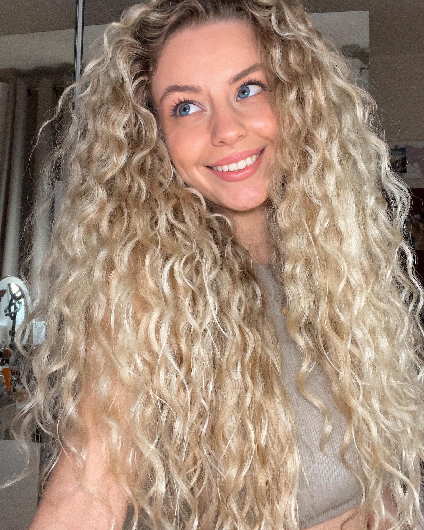 Voluminous Honey Blonde Curls With Face Framing Layers
