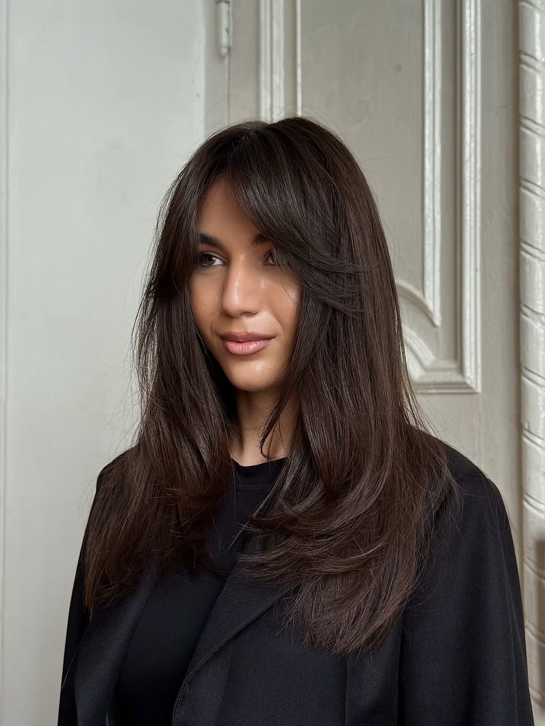Chic Layered Brunette With Face Framing Bangs