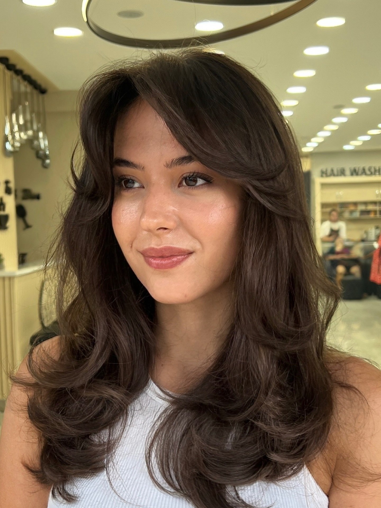 Voluminous Brunette Layers With Face-Framing Bangs