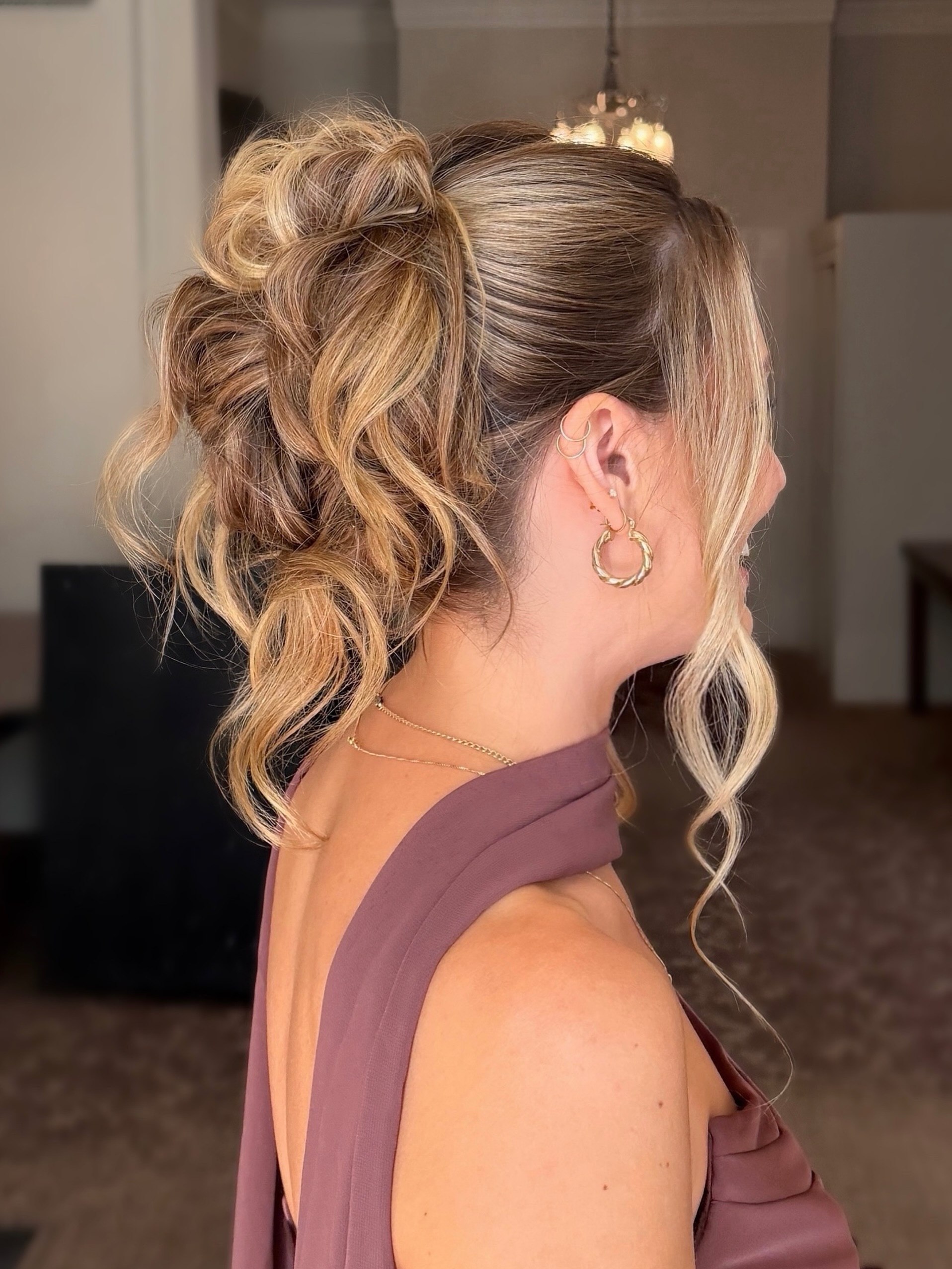 Textured High Bun With Face Framing Tendrils