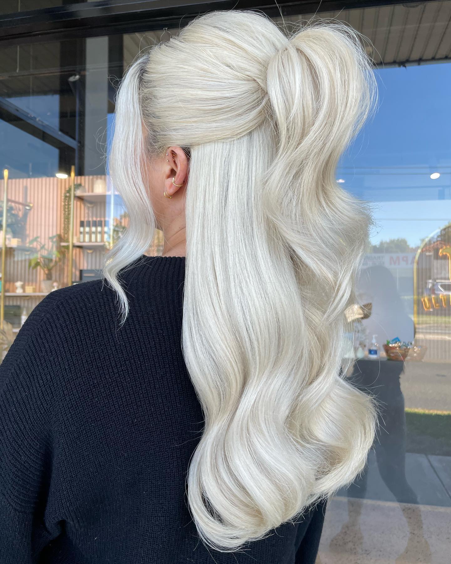 Voluminous Platinum Blonde High Ponytail With Waves