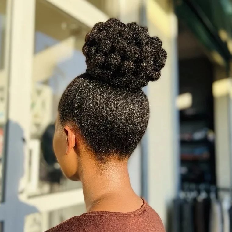Textured High Bun With Sleek Neckline