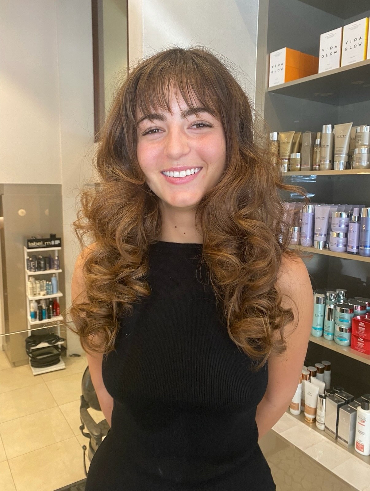 Voluminous Curls With Face-Framing Bangs