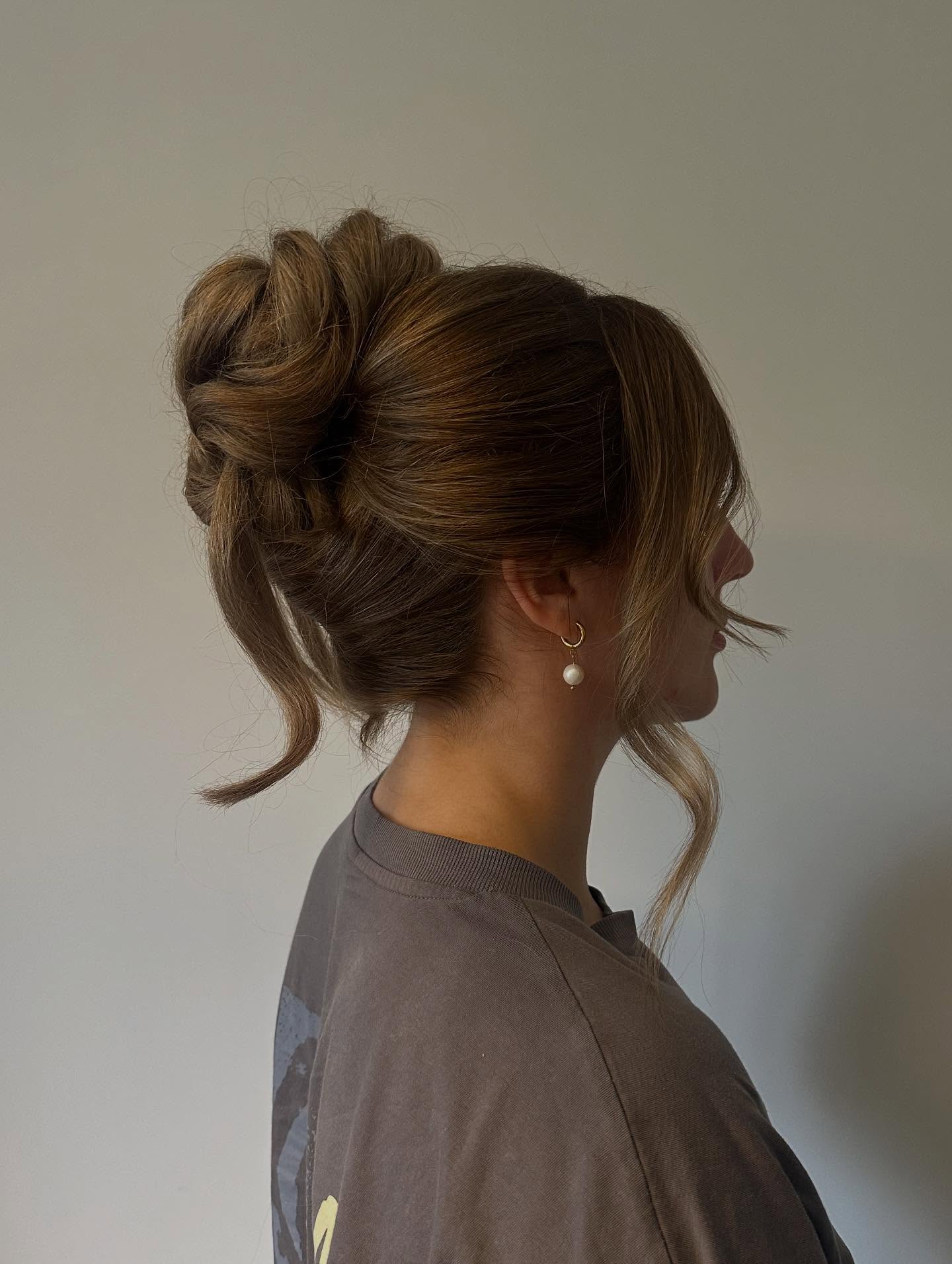 Sophisticated Twisted Updo With Face-Framing Tendrils