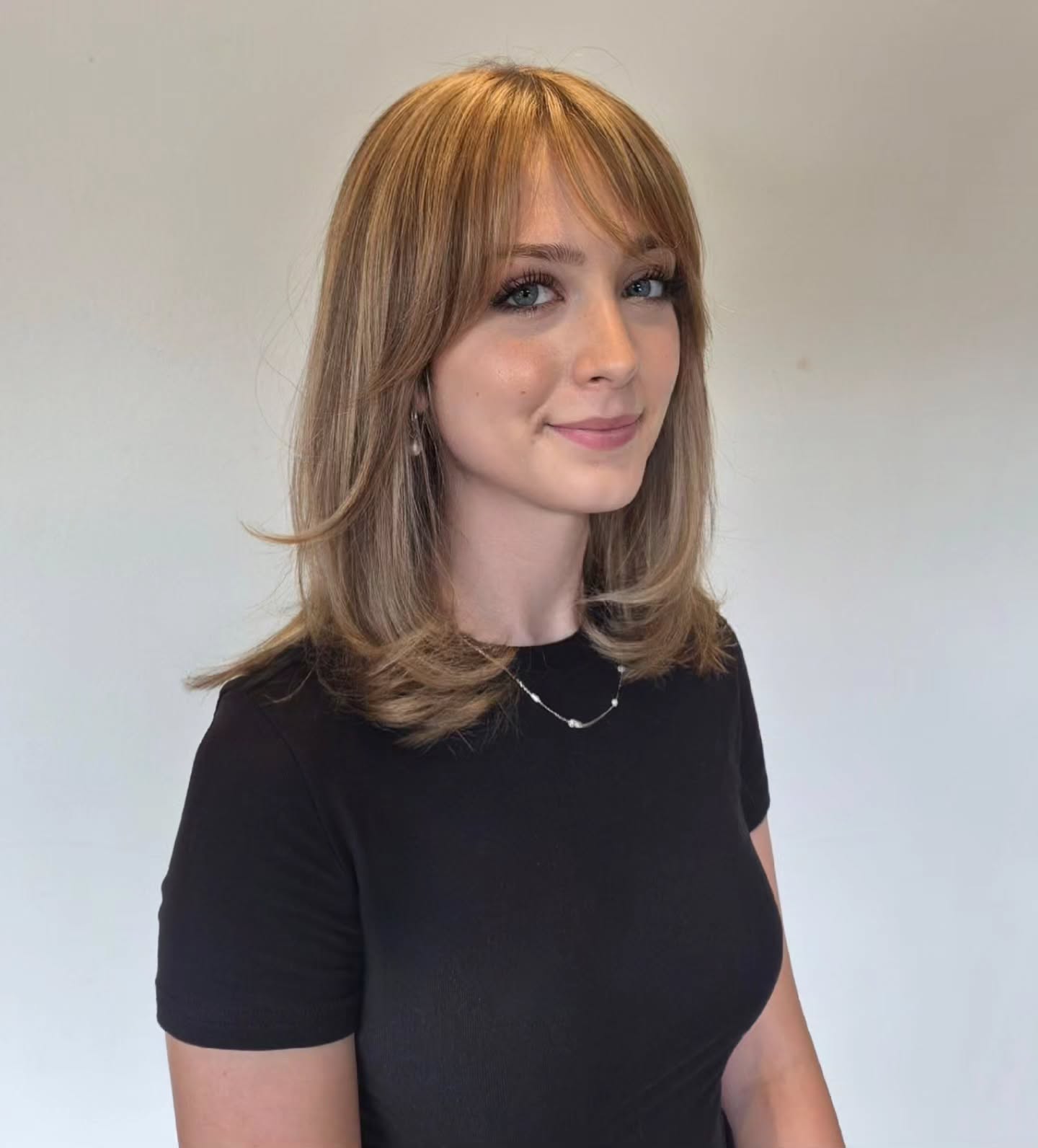 Soft Layered Bangs With Honey Blonde Medium Cut