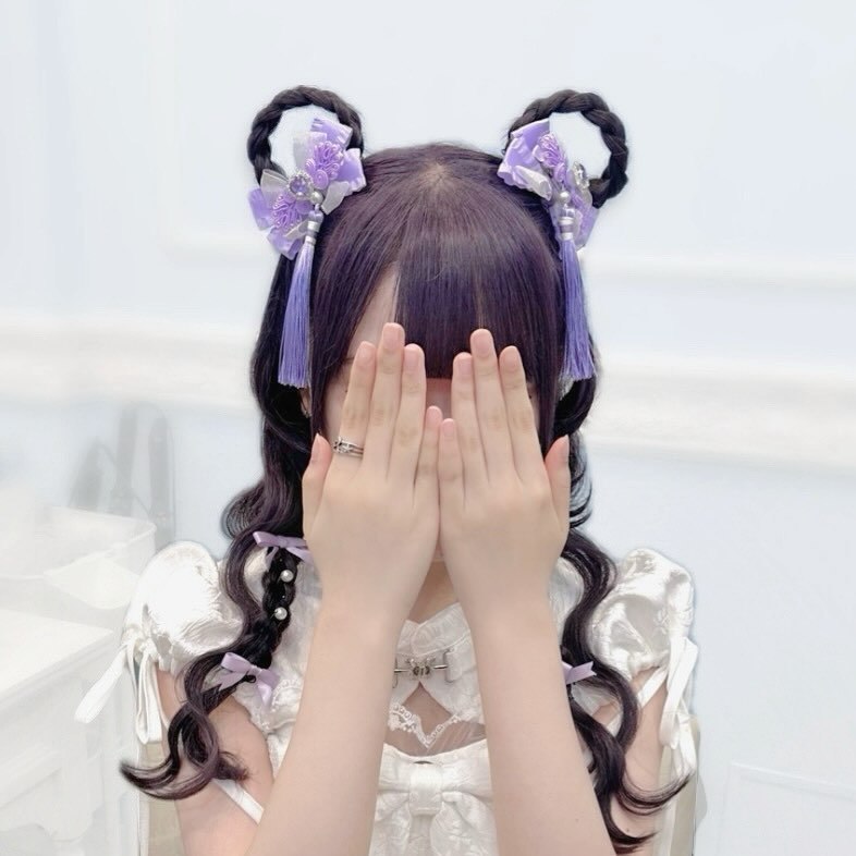 Braided Space Buns With Purple Tassel Charms