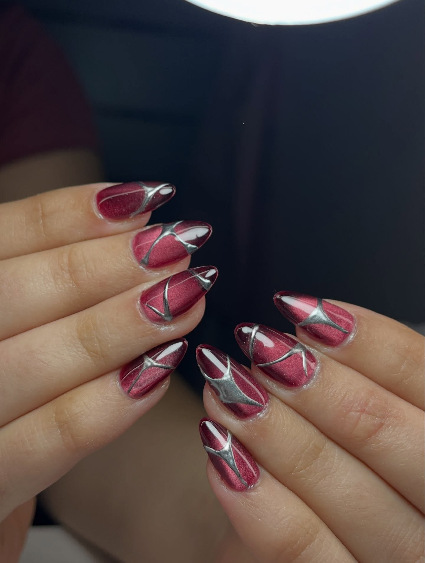 Burgundy Cat Eye Stiletto Nails with Silver Accents