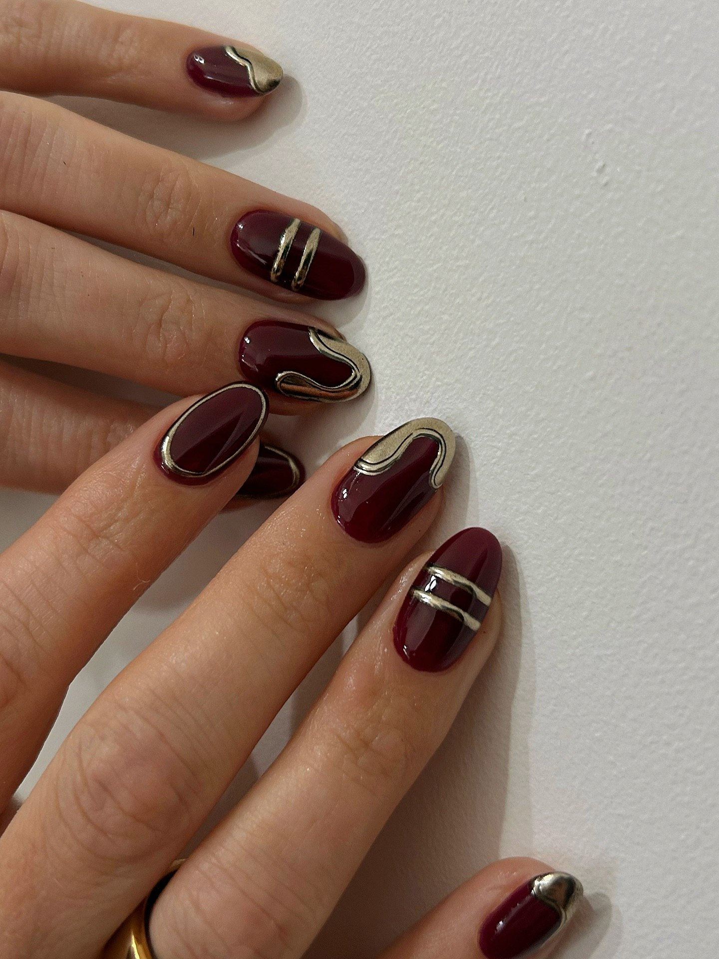 Rich Burgundy Oval Nails With Silver Abstract Art