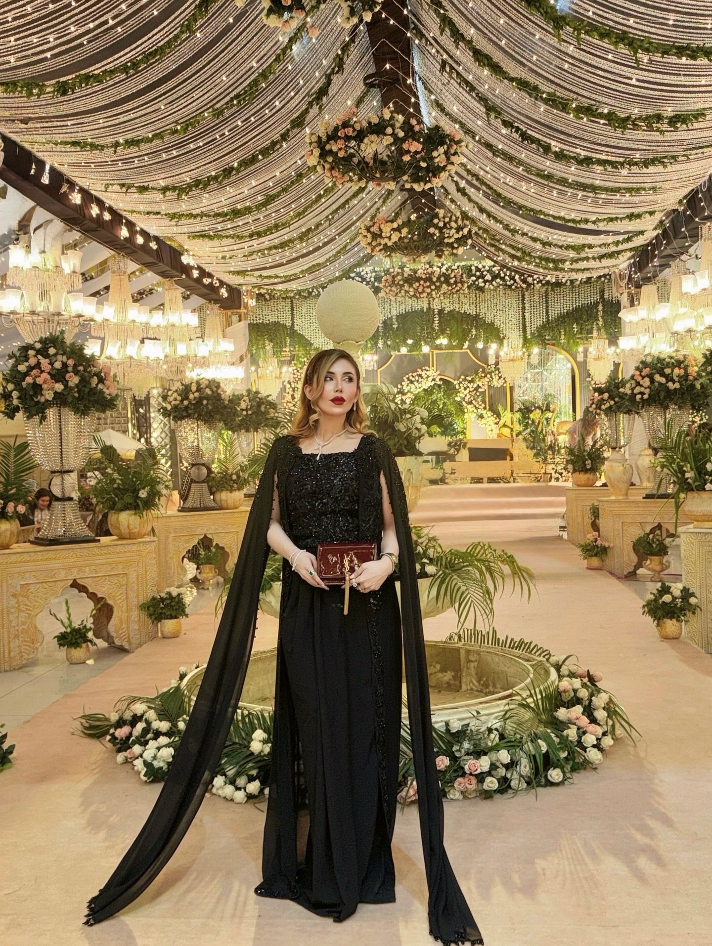 Elegant Black Cape Dress With Red Clutch