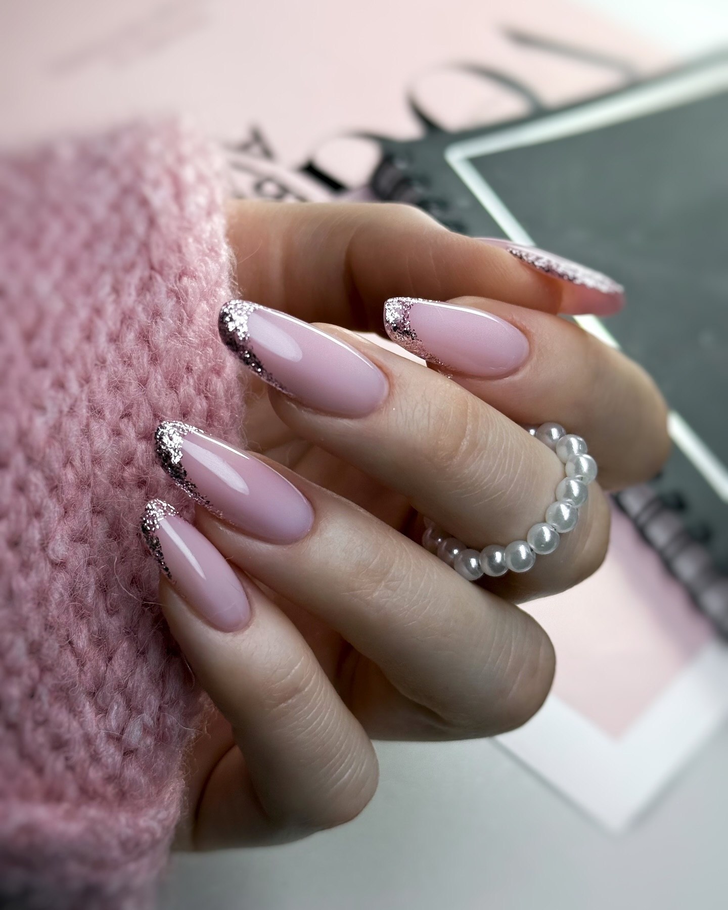 Glossy Pink Almond Nails with Glitter French Tips