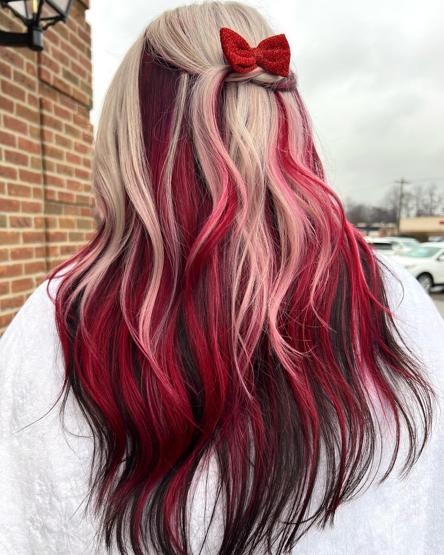 Bold Cherry Red Streaks On Platinum Blonde Waves