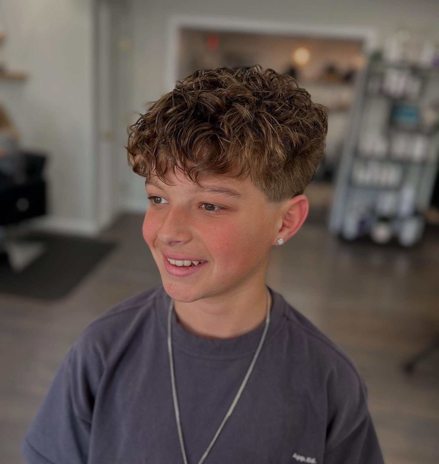 Textured Crop With A Sharp Fade And Natural Curls