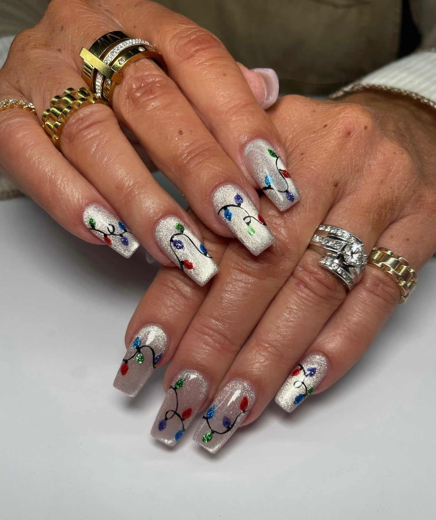 Festive Cat Eye Nails with Holiday Lights Art