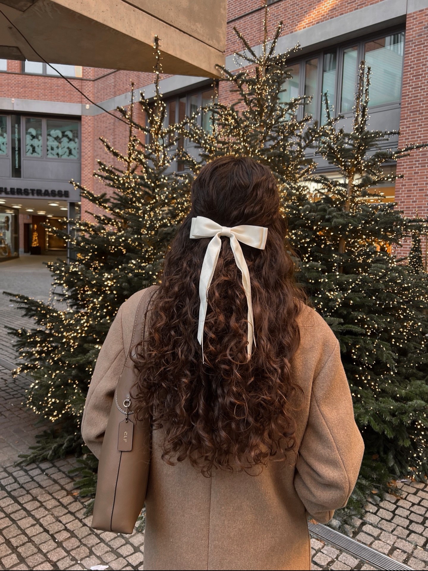 Warm Chestnut Curls With Elegant Cream Bow