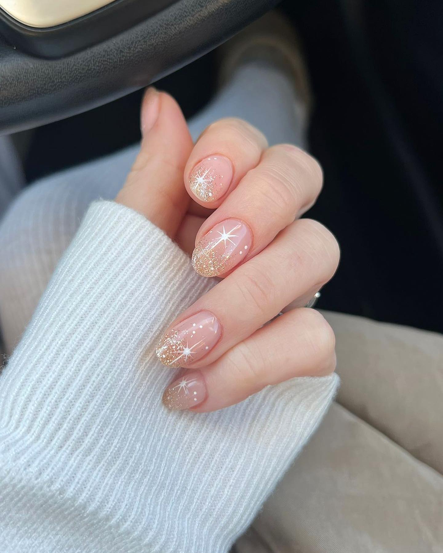 Glossy Nude Nails with Gold Glitter and Starburst Art
