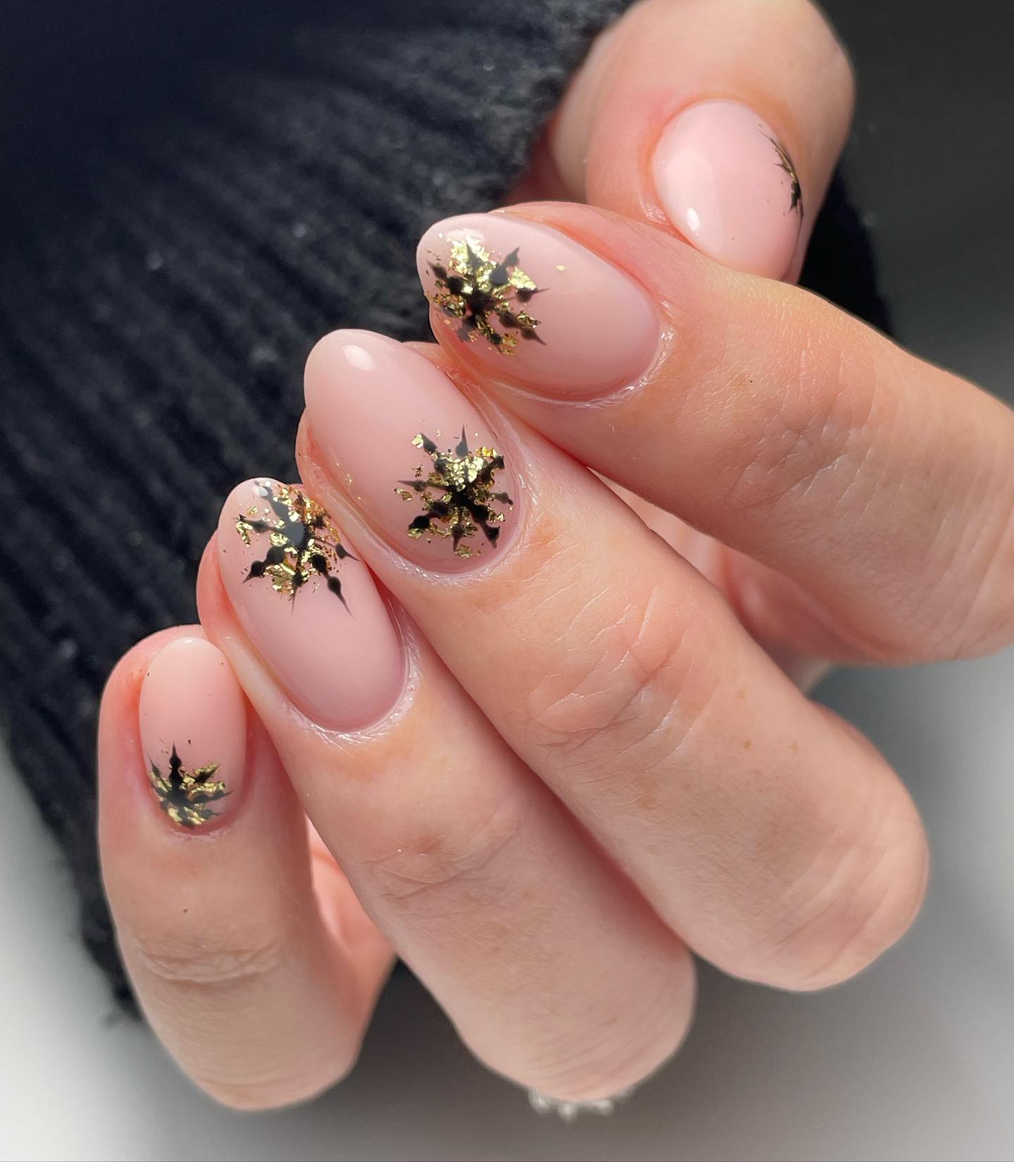 Blush Pink Oval Nails with Gold Snowflake Art