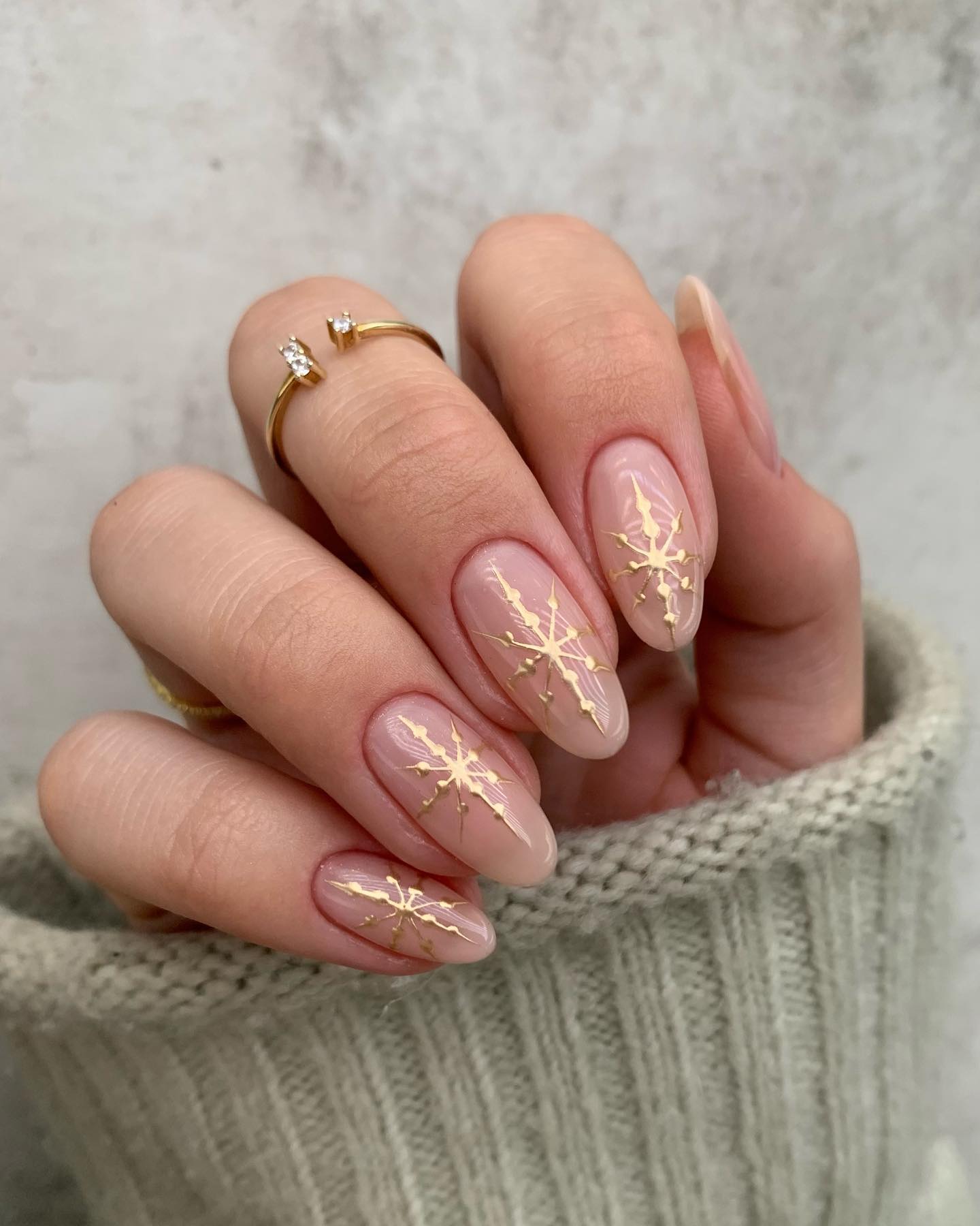 Elegant Gold Snowflake Almond Nails