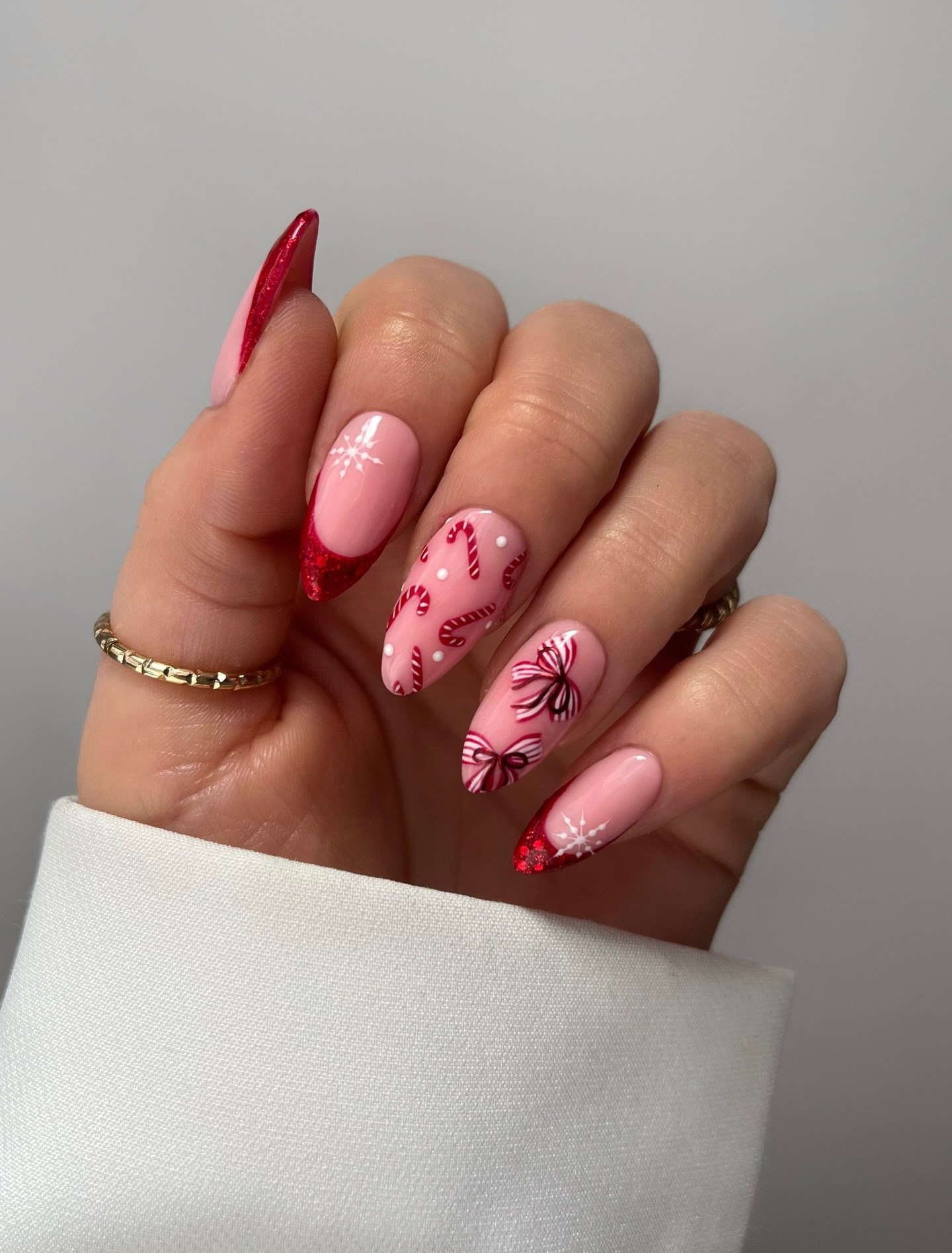 Festive Pink French Tips with Candy Cane Bows