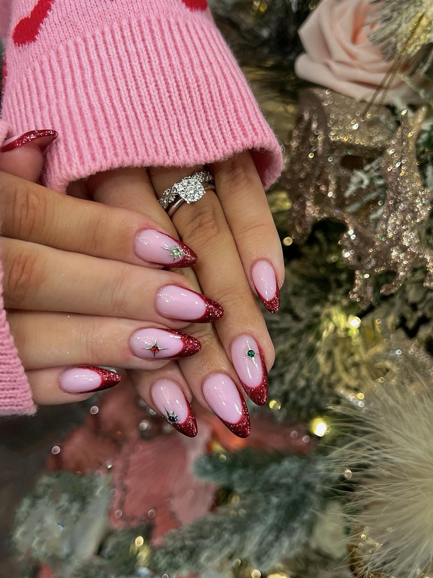 Sparkly Red French Tip Almond Nails with Star Gems