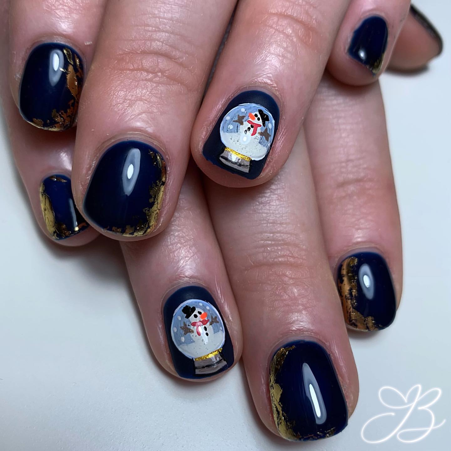 Enchanting Snow Globe Nails with Gold Foil Accents