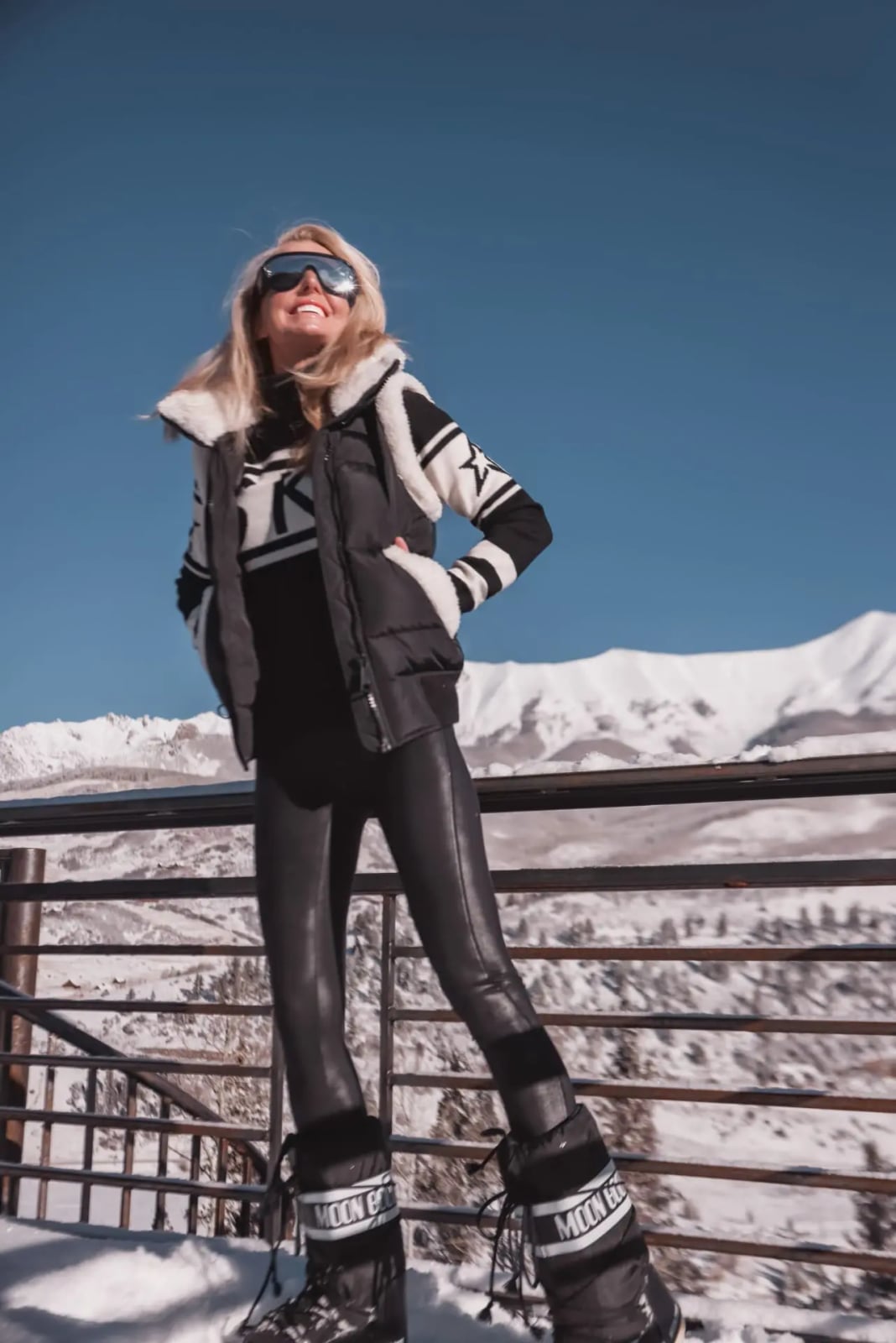 Black Puffer Vest with Faux Fur Trim and Patterned Sweater — Ski Outfits for Women