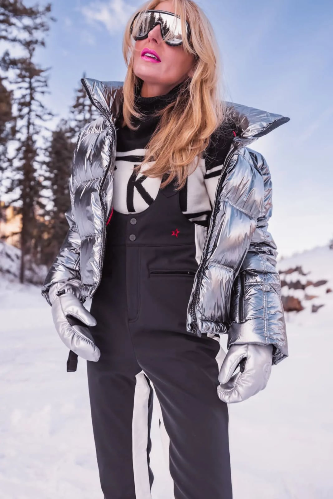 Silver Metallic Puffer Jacket Over Black Ski Overalls — Ski Outfits for Women