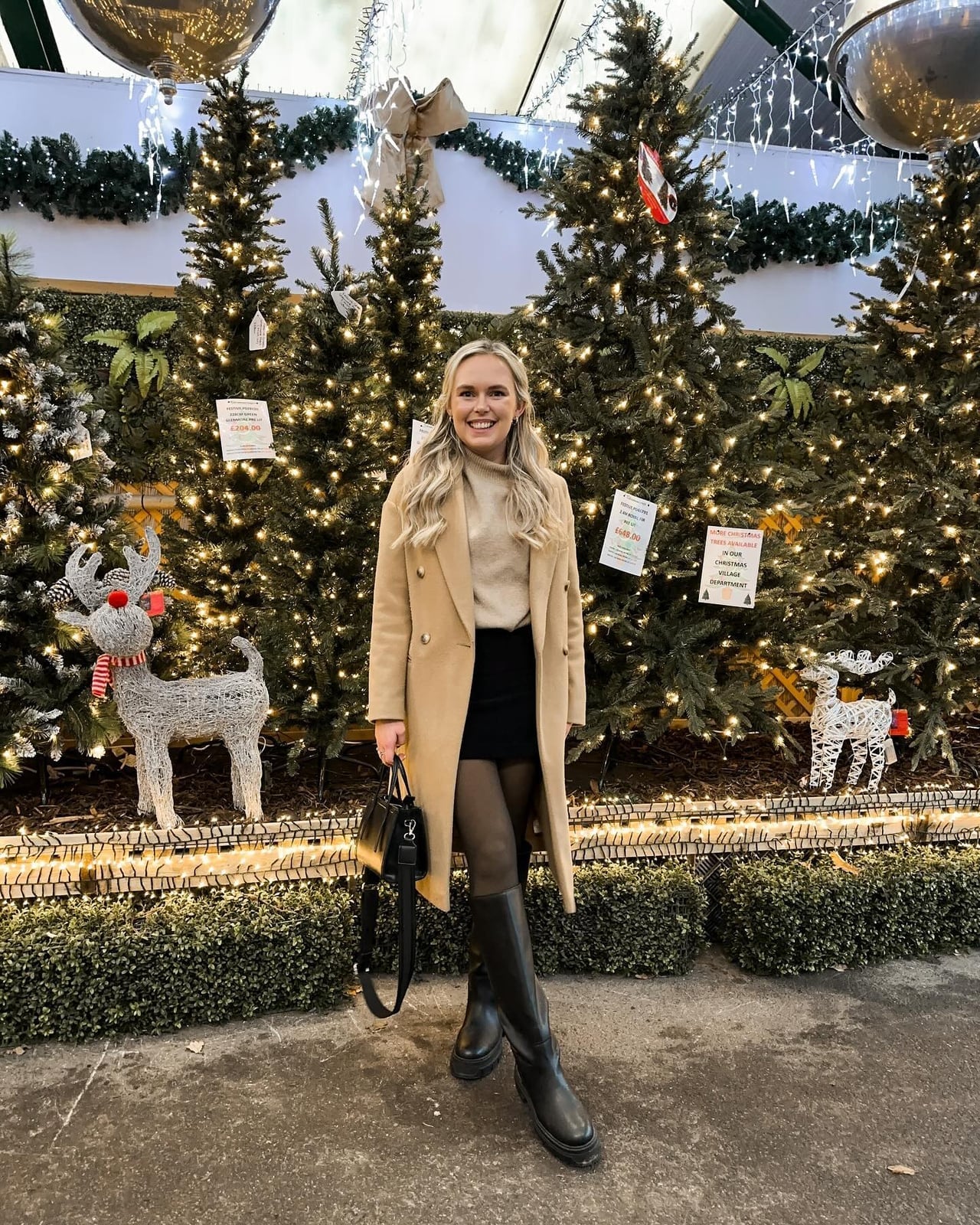 Camel coat over beige turtleneck and black mini skirt — Christmas Eve Outfits
