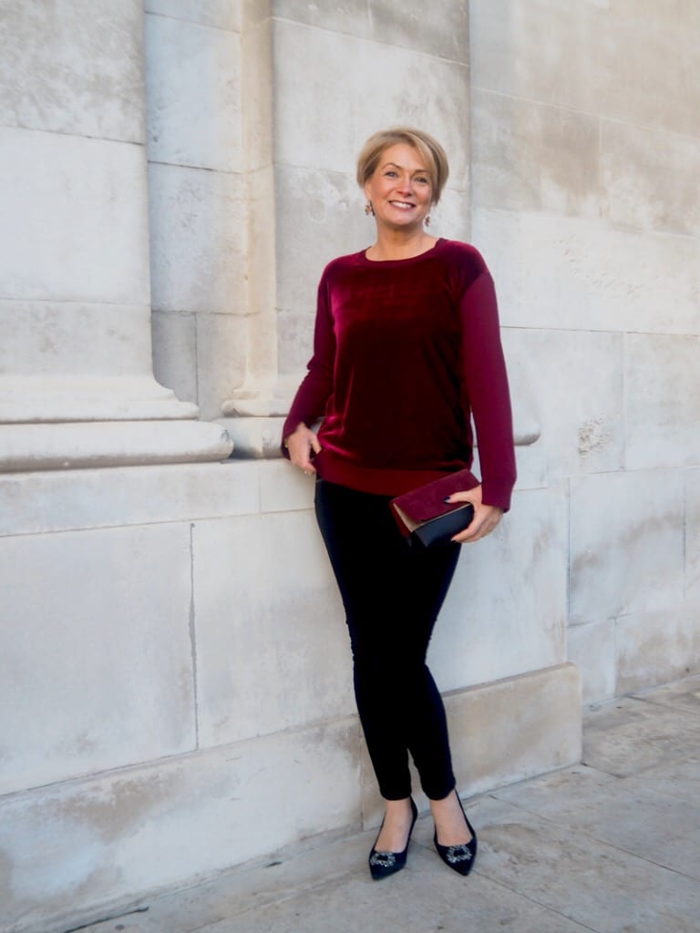 Burgundy velvet top with black fitted trousers — Christmas Eve Outfits