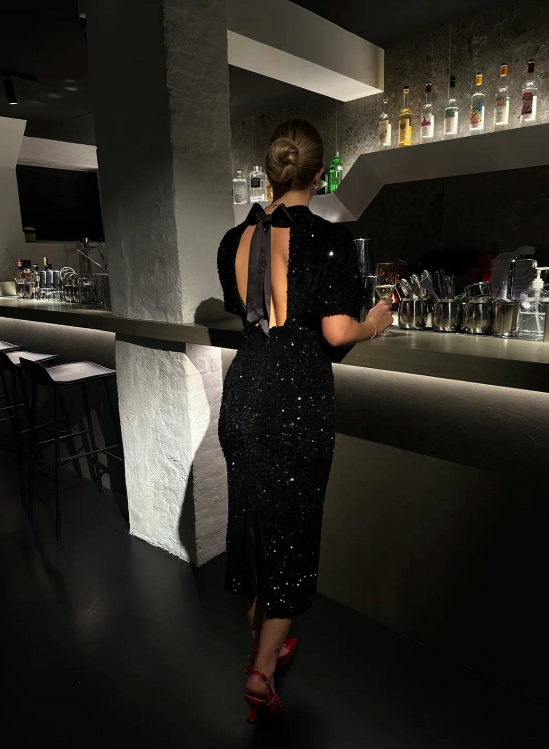 Black sequin midi dress with open back and bow detail — Christmas Eve Outfits