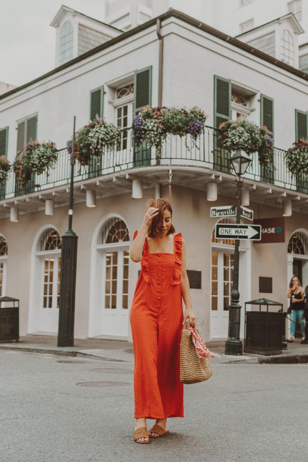 Vibrant Orange Ruffled Jumpsuit with Straw Bag — Aesthetic Orange Outfits
