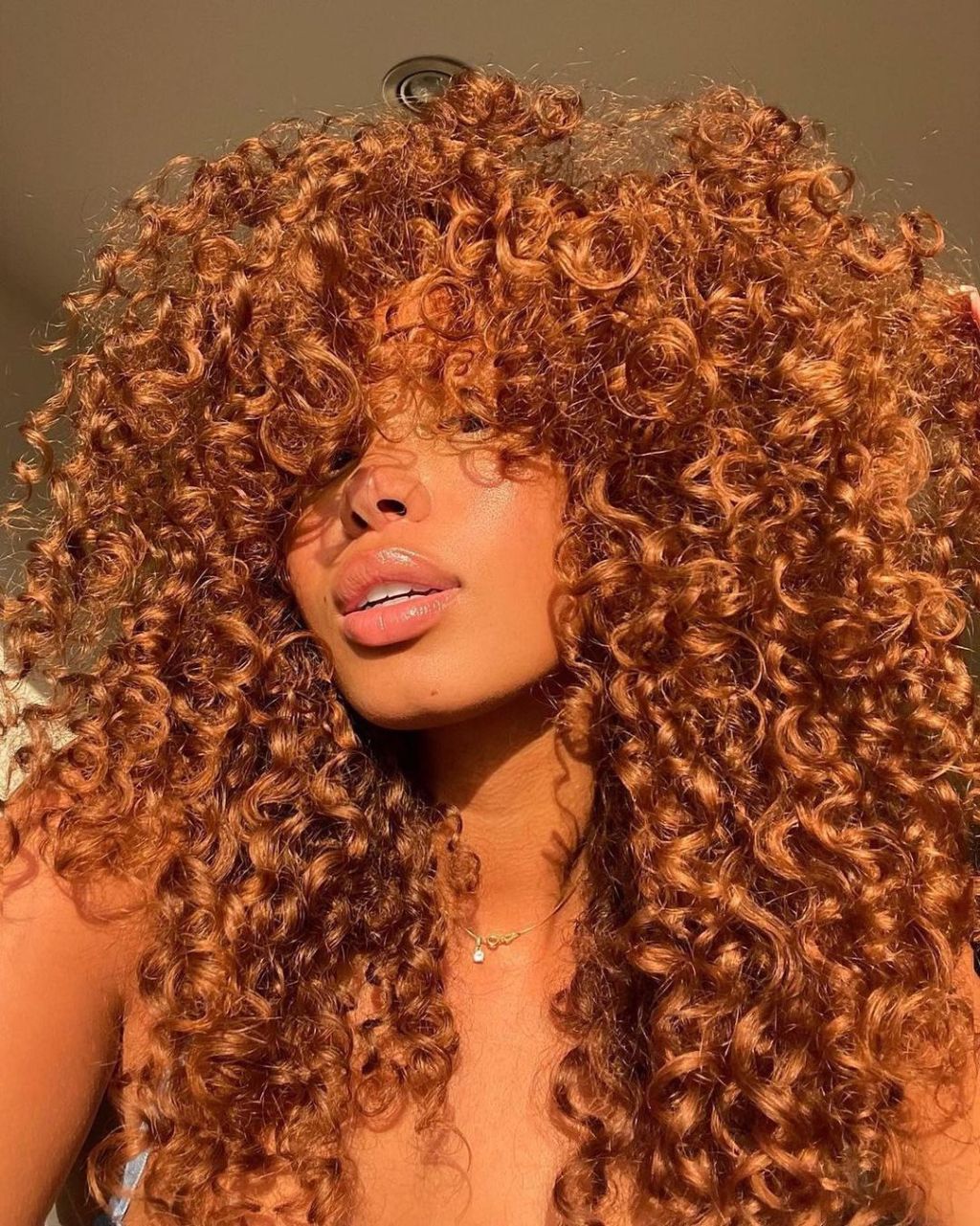 Voluminous Fiery Auburn Curls With Full Bangs Voluminous Fiery Auburn Curls With Full Bangs — Auburn Hair Color