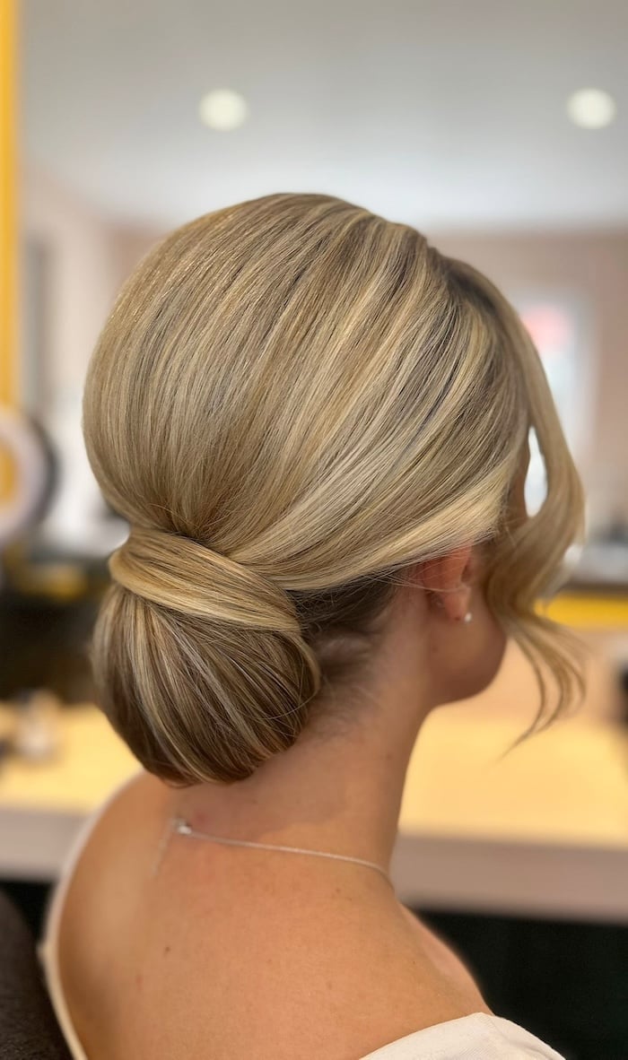 Vanilla Beige Blonde Sleek Bun With Glossy Tendrils — Low Bun Wedding Hair
