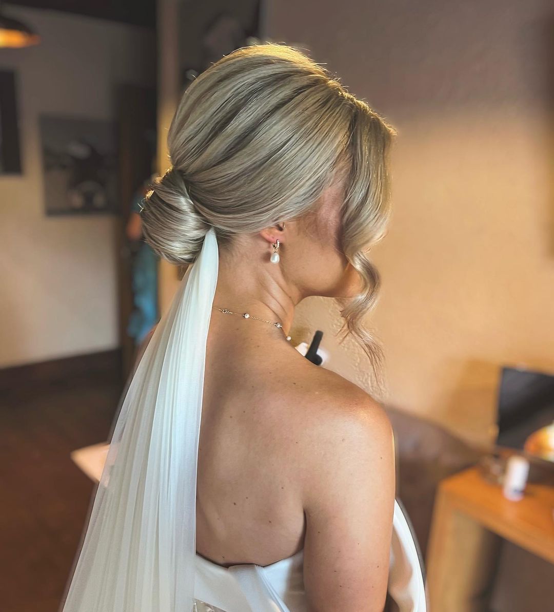 Voluminous Blonde Low Bun With Soft Waves and Veil — Low Bun Wedding Hair