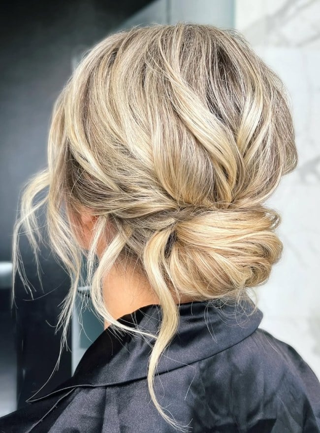 Textured Blonde Low Bun With Soft Tendrils — Low Bun Wedding Hair