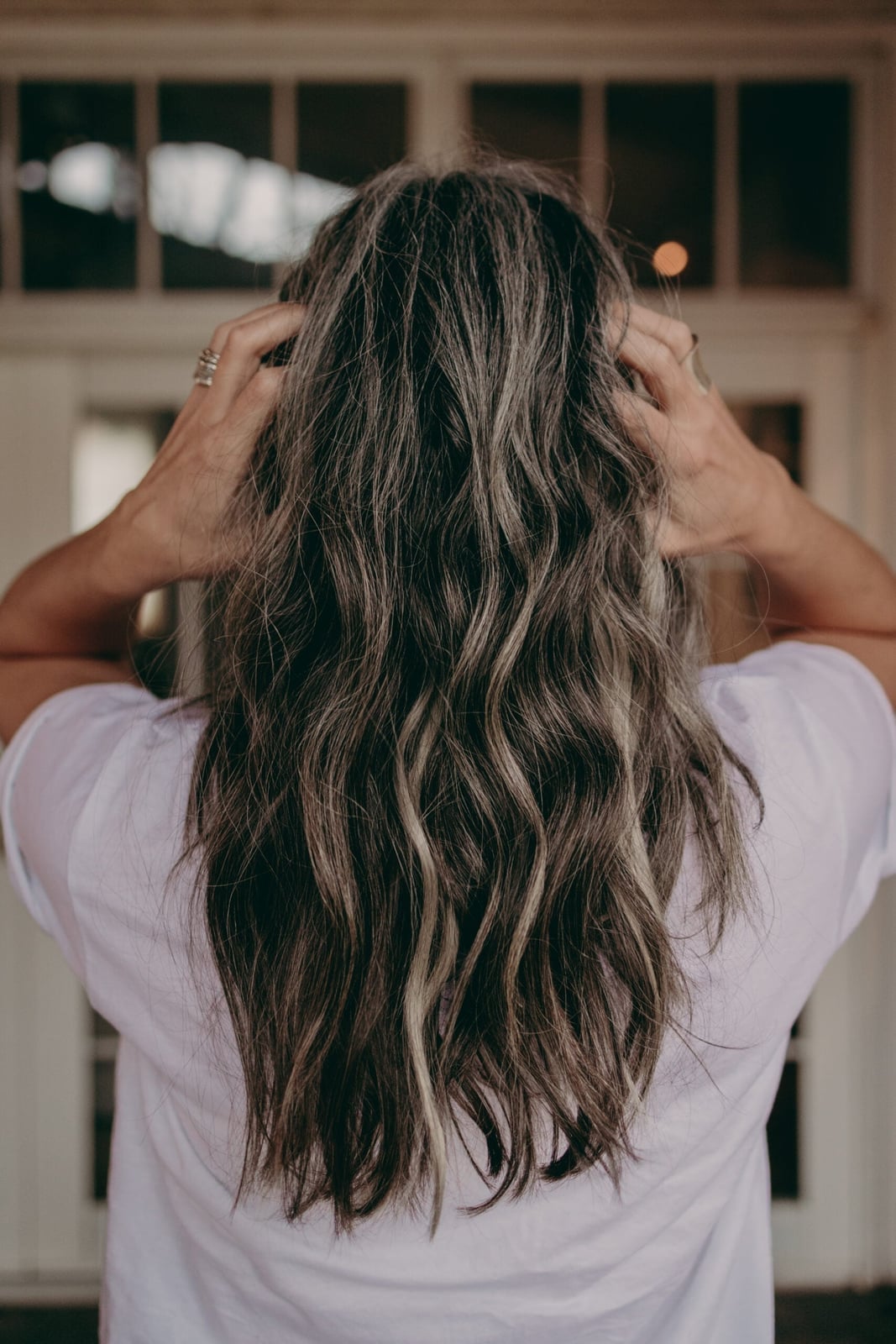 Shoulder Length Natural Gray With Loose Curls — Trendy Grey Highlights